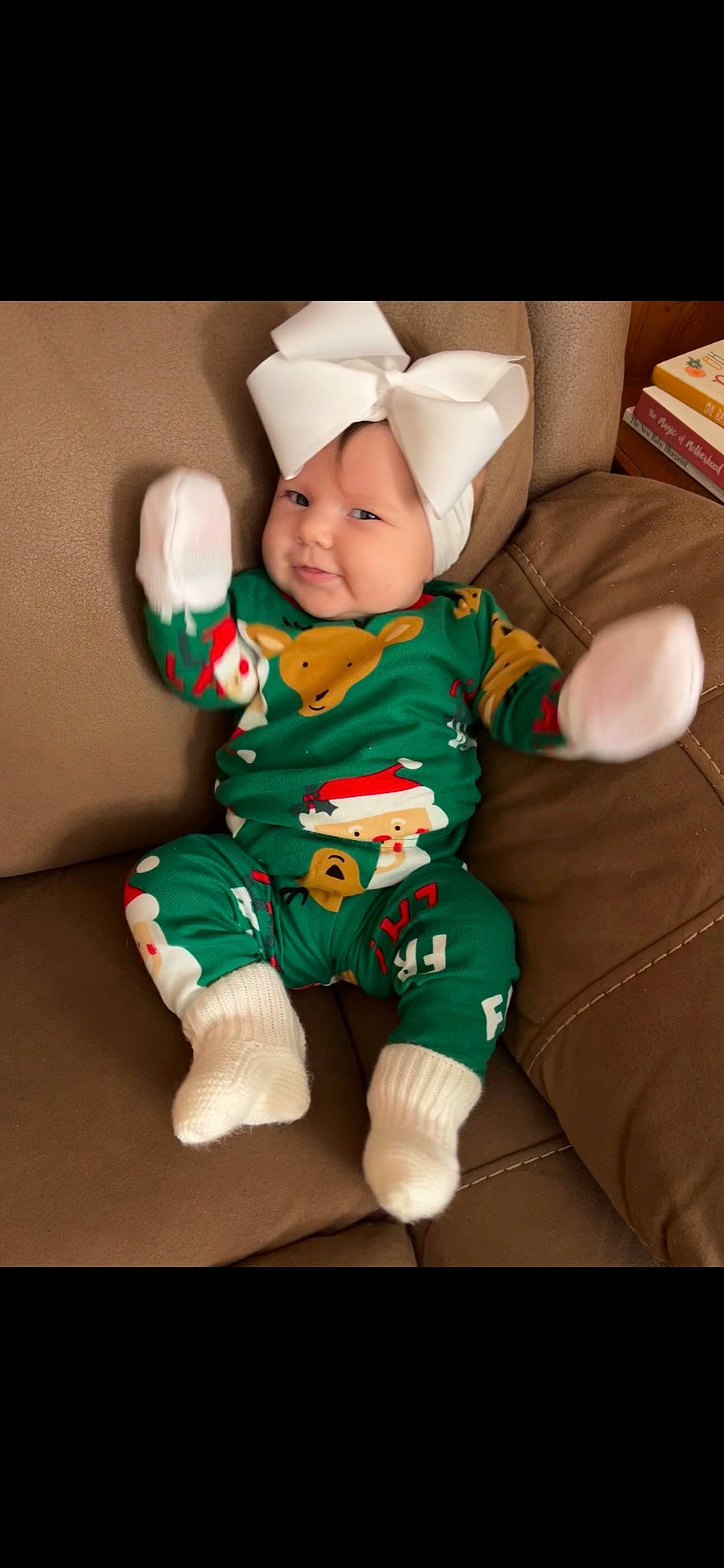 Landry is registered to the contest to win money with this photo: baby, baby_toddler_clothing, carmine, christmas, comfort, event, face, fictional_character, fun, happy, head, headwear, holiday, lap, leg, linens, person, sleeve, smile, sock