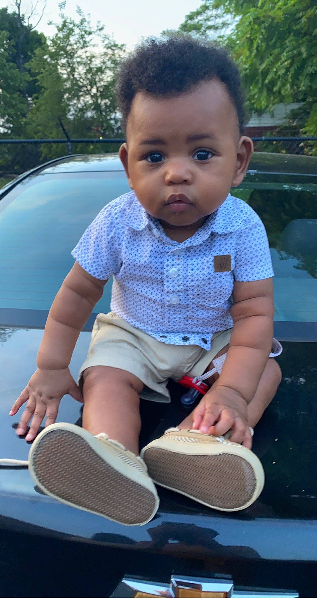 Jamir is registered to the contest to win money with this photo: arm, automotive_lighting, baby_toddler_clothing, black, car, cool, finger, fun, grass, hairstyle, hand, hood, leisure, motor_vehicle, person, plant, shorts, sneakers, toddler, toy