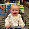 Colsen is registered to the contest to win money with this photo: aisle, baby, bib, child, clothing, cute, face, hand, happy, indoor, infant, package, person, retail, seat, shopping, shopping_cart, smile, store, toy