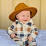 Colsen is registered to the contest to win money with this photo: baby, child, hat, smile, happy, infant, plaid, onesie, pillow, soft, cozy, cute, seated, portrait, indoor, wearing, footwear, clothing, expression, warm