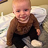 baby, black_pants, blanket, brown_shirt, child, clothing, cozy, cute, eyes, face, happy, indoor, infant, portrait, sitting, smile, soft_texture, warm, white_socks, young