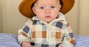 Colsen joined the competition — help win amazing prizes! baby, blue_eyes, checkered_outfit, child, cozy, cushion, cute, fashion, footwear, hands_clenched, hat, indoor, infant, neutral_background, portrait, sitting, soft_lighting, striped_cushion, warm_colors, young_child