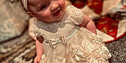 Henley is registered to the contest to win money with this photo: accessories, baby, clothing, costume, dress, face, flower, formalwear, happy, head, laughing, lighting, person, photography, plant, portrait, pottedplant, sitting, smile, tree