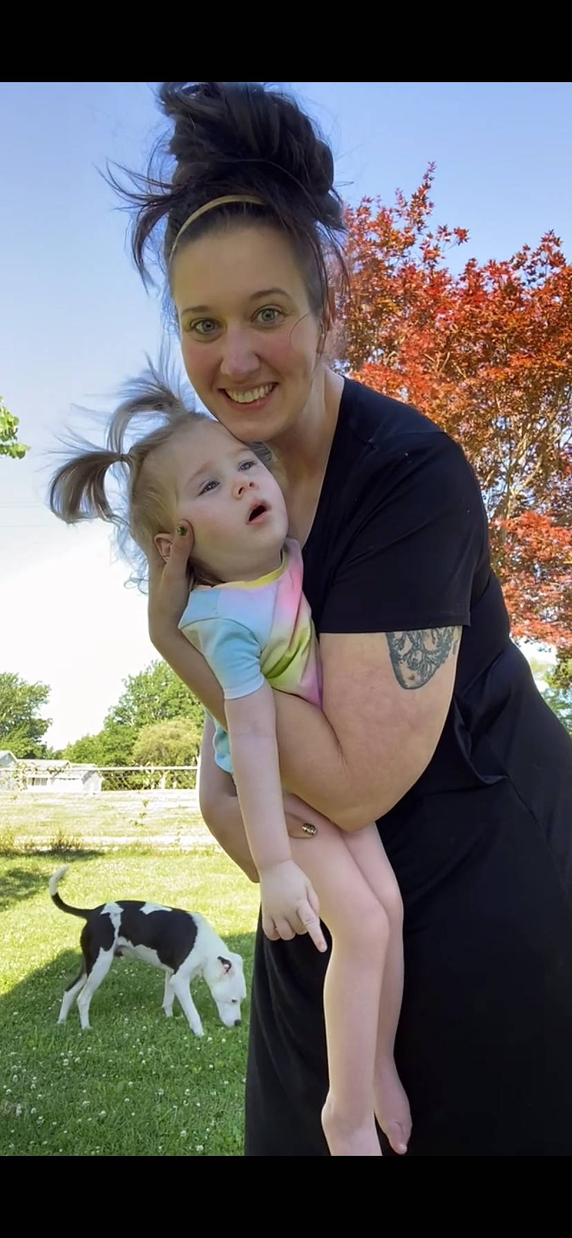 Mckinlee is registered to the contest to win money with this photo: baby, carnivore, child, companion_dog, dog, dog_breed, face, fun, gesture, grass, hair, happy, joy, leisure, people_in_nature, person, plant, sky, smile, toddler