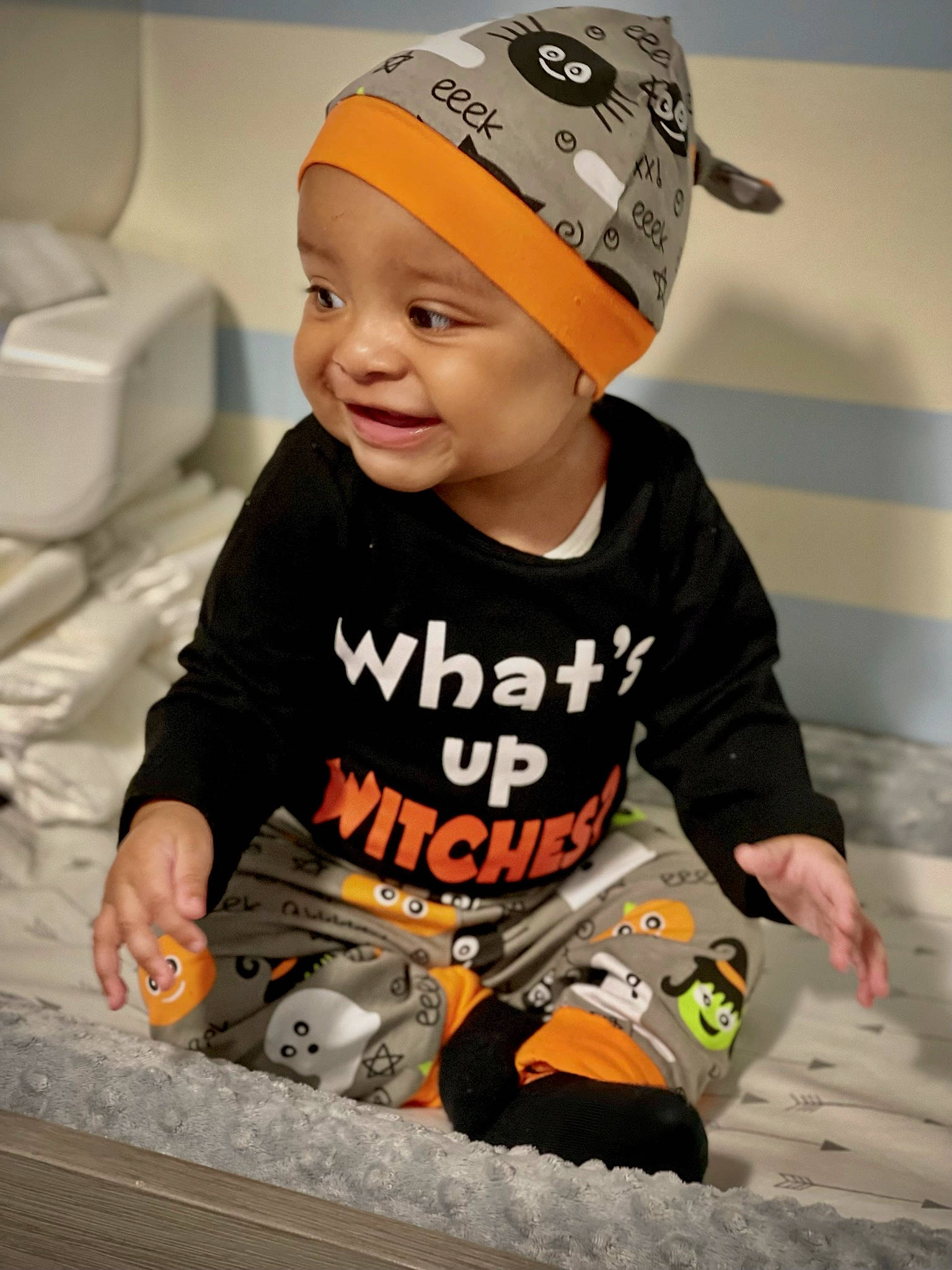 Emmitt is registered to the contest to win money with this photo: baby, baby_toddler_clothing, baseball_cap, cap, child, face, flooring, fun, happy, headgear, headwear, orange, people, person, personal_protective_equipment, shorts, sitting, sleeve, smile, t_shirt