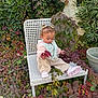 toddler, child, chair, outdoor, plants, foliage, leaves, greenery, nature, pigtails, pink_shoes, jacket, pants, curly_hair, garden, pot, wall, daylight, casual_clothing, exploring