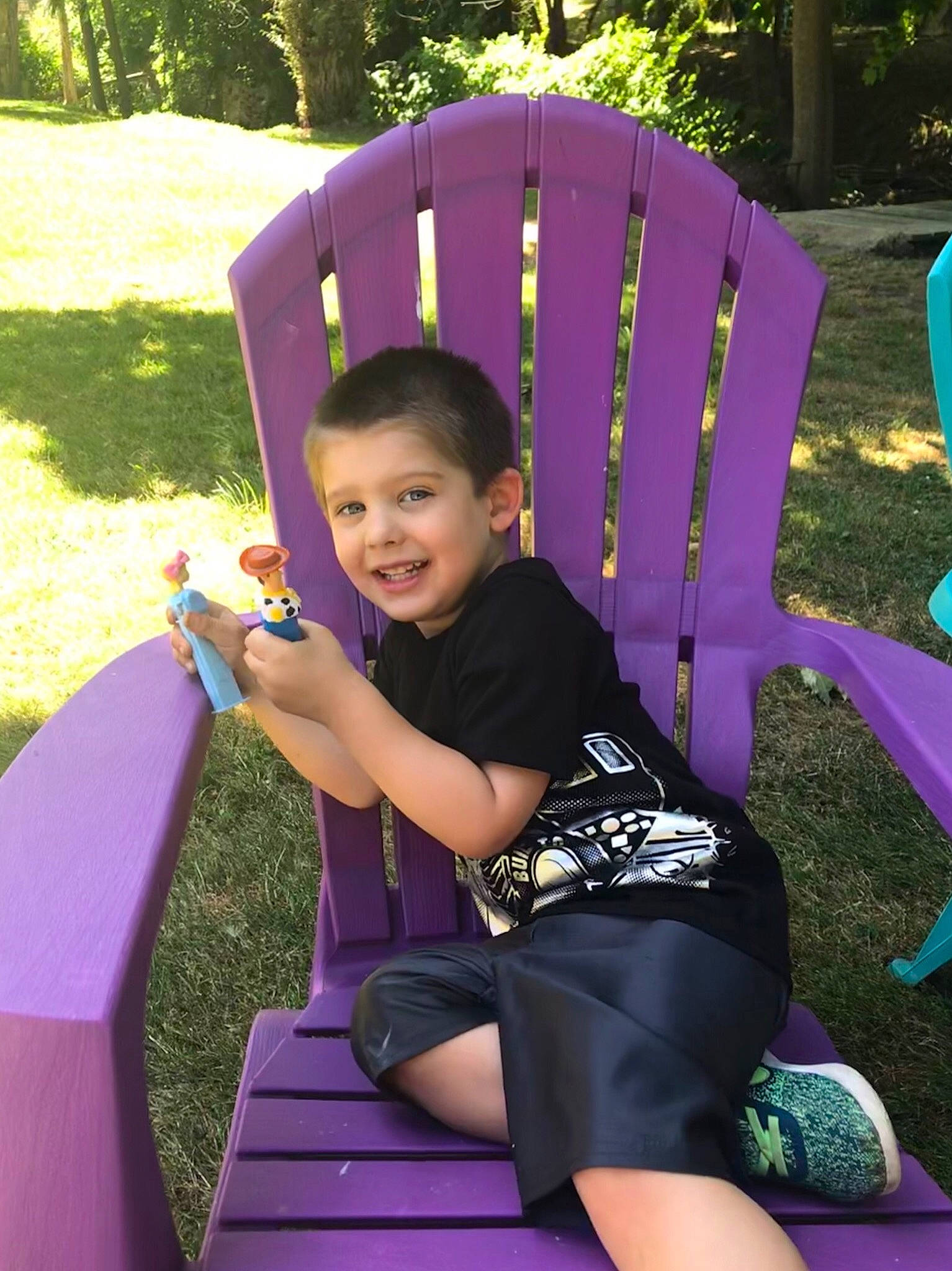 Zander is registered to the contest to win money with this photo: child, fun, grass, human_settlement, joy, leisure, magenta, outdoor_play_equipment, person, pink, plant, play, playground, public_space, purple, recreation, sitting, smile, summer, toddler