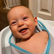Knox is registered to the contest to win money with this photo: baby, smiling, towel, wrapped, indoor, door, wood, happy, child, infant, face, skin, expression, bath, portrait, cute, person, closeup, head, warm