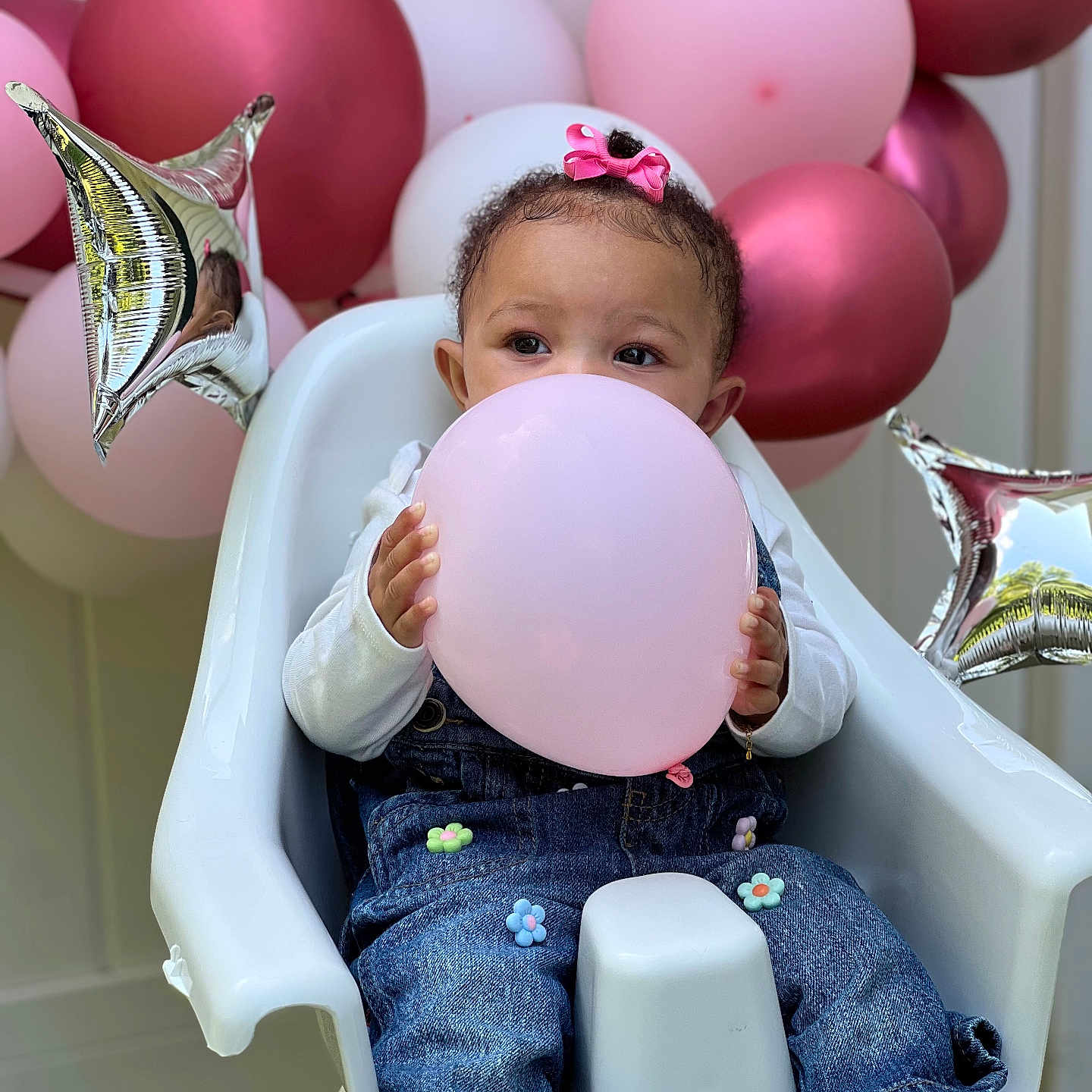 Nalani joined the competition — help win amazing prizes! baby, balloon, bodypart, chair, clothing, eating, face, finger, footwear, furniture, hand, happy, head, jeans, pants, person, shoe, sitting, smile, sphere