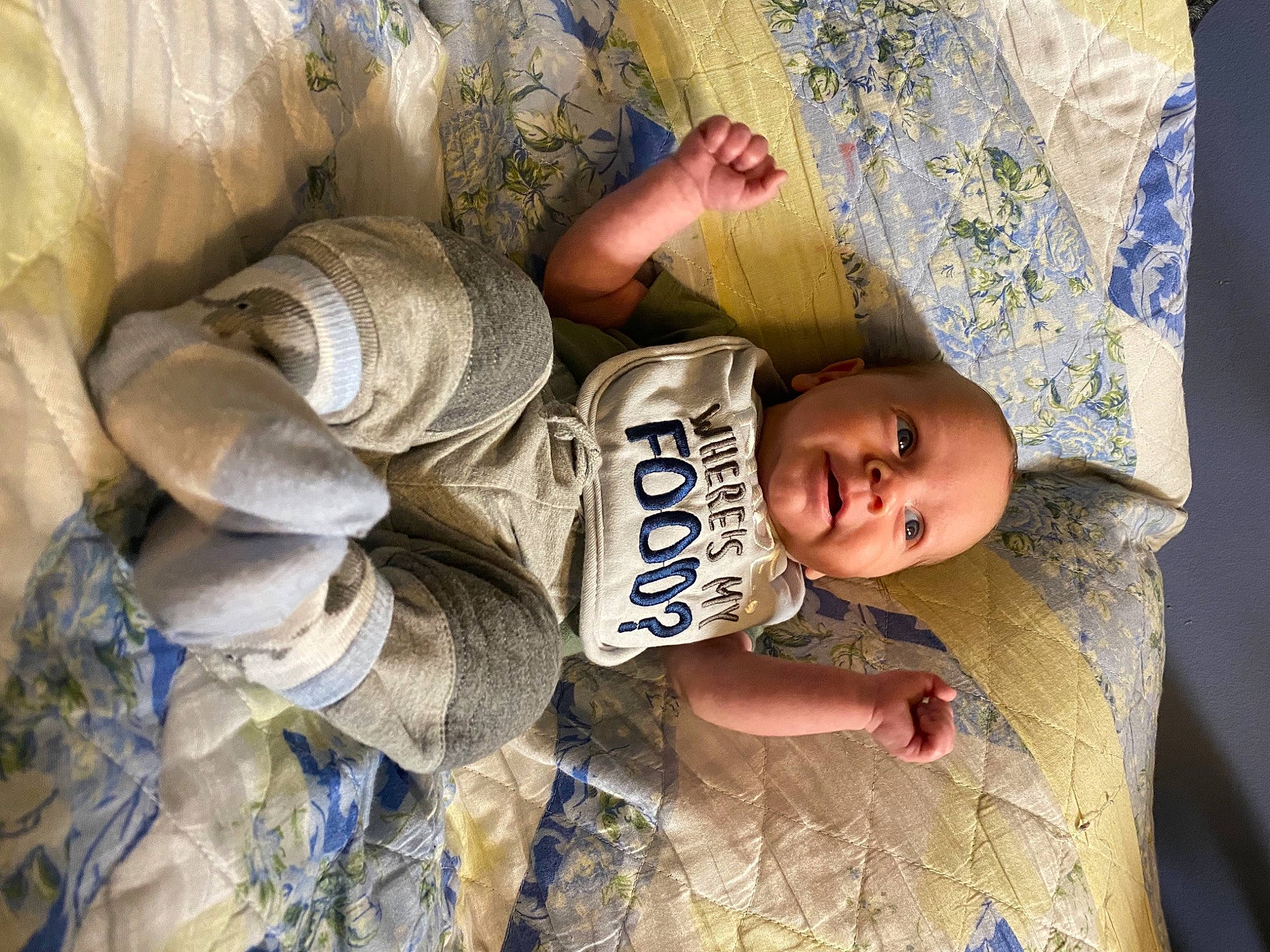 Kaiden is registered to the contest to win money with this photo: baby, child, eye, fun, happy, hat, human_body, pattern, person, portrait_photography, sitting, smile, soil, sun_hat, textile, toddler, tree, wood
