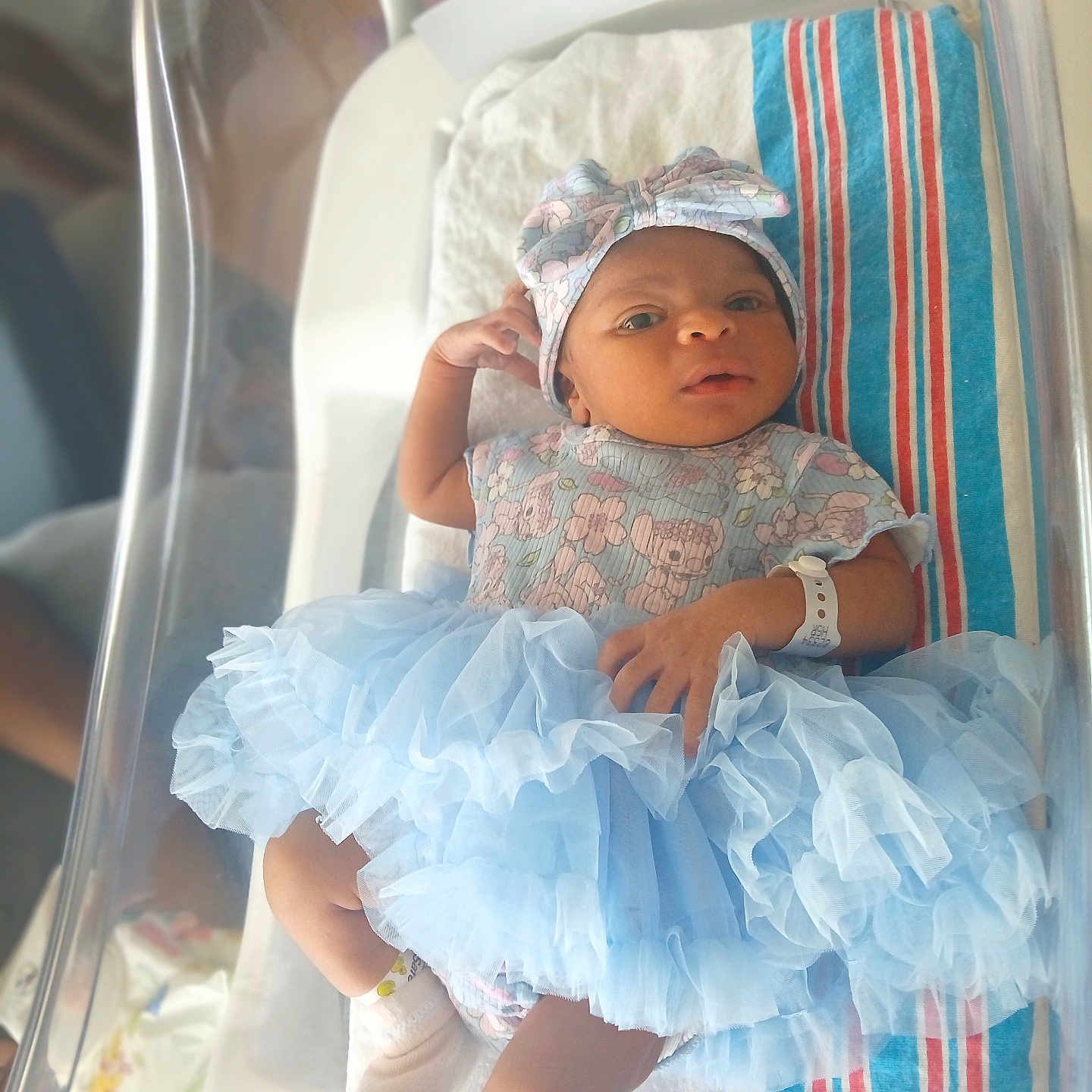 Zipporah is registered to the contest to win money with this photo: baby, baby_clothes, bassinet, blanket, clothing, cute, headband, hospital, hospital_bed, indoor, infant, laying_down, newborn, newborn_baby, person, portrait, sock, soft_light, tutu, wristsband