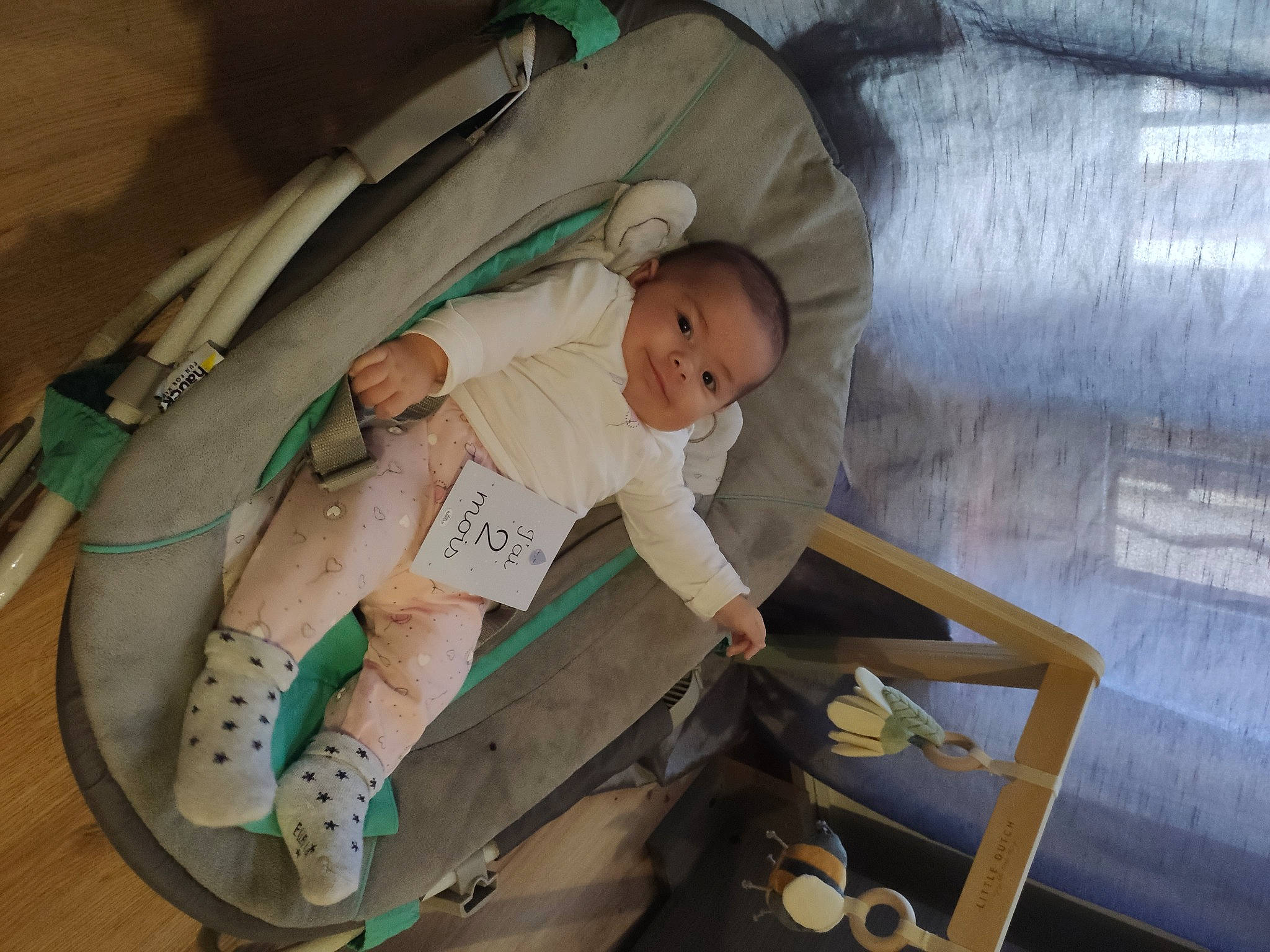 Kylie participe au concours pour gagner de l'argent avec cette photo : baby, baby_products, baby_safety, baby_toddler_clothing, child, comfort, cradle, foot, hardwood, infant_bed, lap, leisure, linens, person, product, room, sitting, sock, thigh, toddler