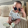 Liam joined the competition — help win amazing prizes! baby, child, sunglasses, overalls, shirt, couch, furniture, indoor, cute, infant, footwear, shoes, expression, face, hand, seated, plush, striped, window, decor