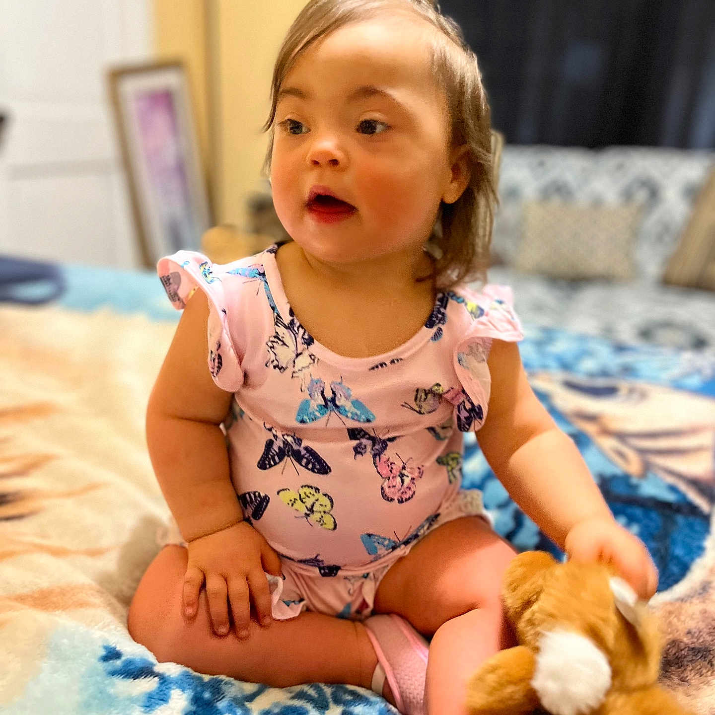 Junevae is registered to the contest to win money with this photo: bed, blanket, bunny, butterfly_pattern, casual, child, cozy, cross_legged, curly_hair, cute, home, indoor, pink_clothing, plush_toy, portrait, sitting, soft_focus, toddler, toy, young_child