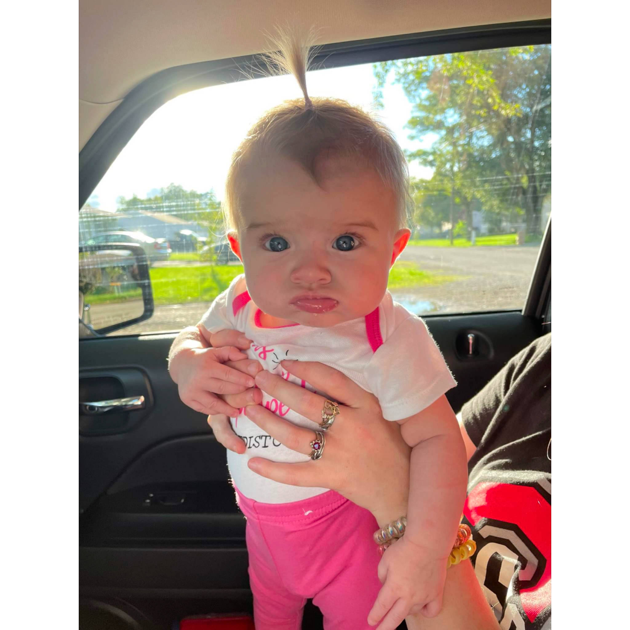 Haizleigh Taynor is registered to the contest to win money with this photo: auto_part, automotive_exterior, automotive_mirror, baby, baby_toddler_clothing, car, car_seat, family_car, grass, happy, motor_vehicle, person, plant, rear_view_mirror, sky, thumb, toddler, tree, vehicle_door, wheel
