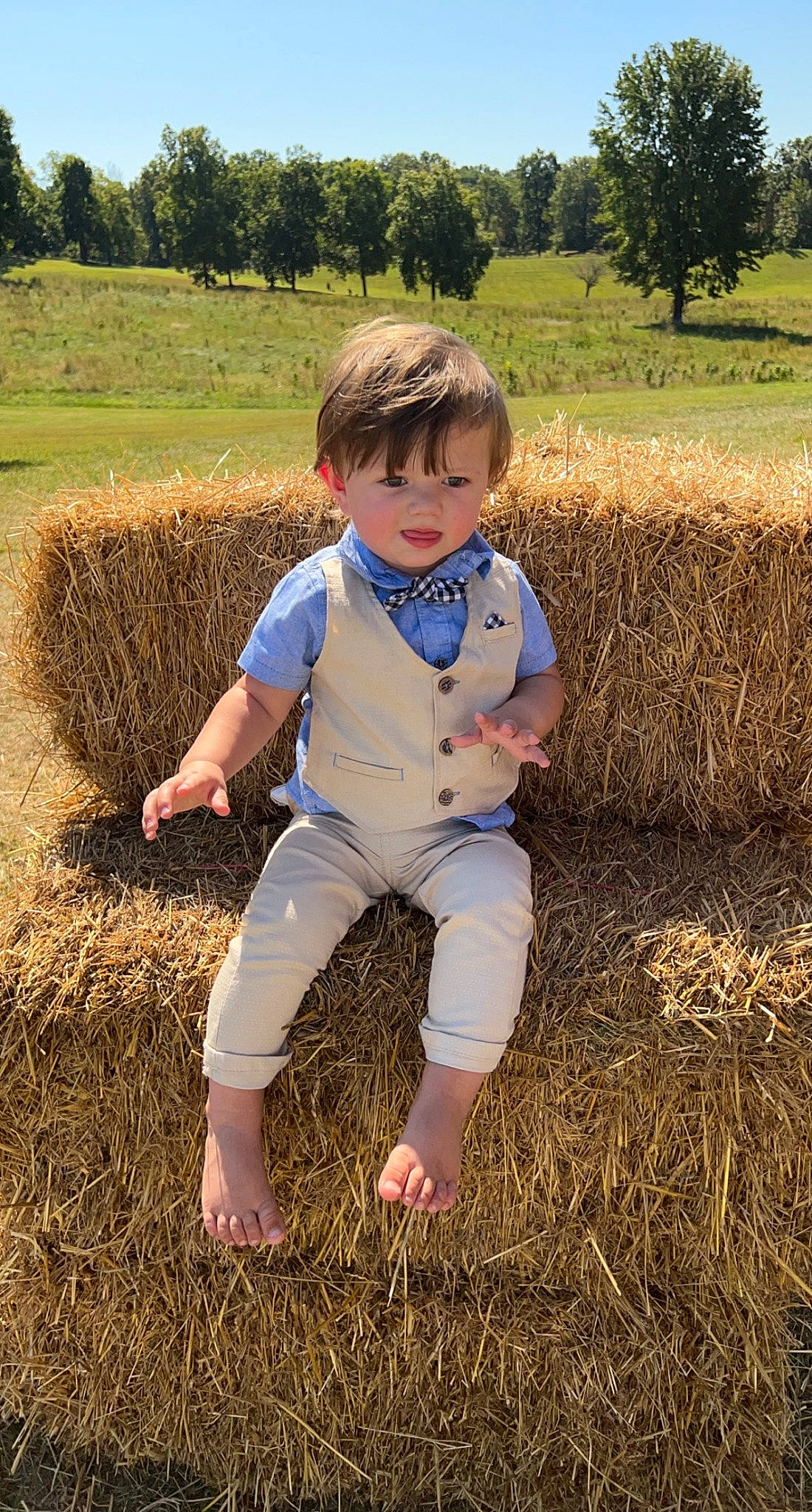 Levi is registered to the contest to win money with this photo: agriculture, baby_toddler_clothing, child, farmworker, field, fun, grass, grass_family, grassland, happy, hay, landscape, people_in_nature, person, plant, prairie, sky, soil, t_shirt, toddler