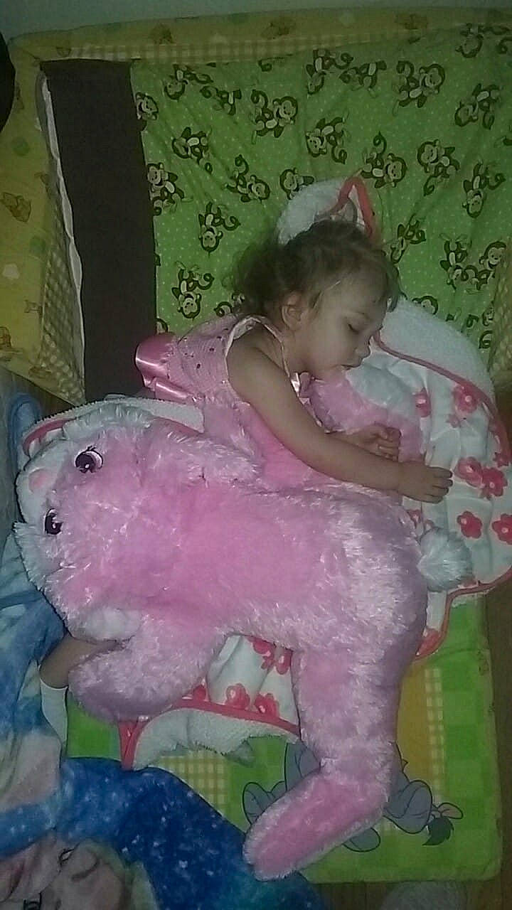 Annabelle is registered to the contest to win money with this photo: bedtime, child, eye, face, fun, girl, green, head, infant, mouth, person, pink, play, product, skin, textile, toddler