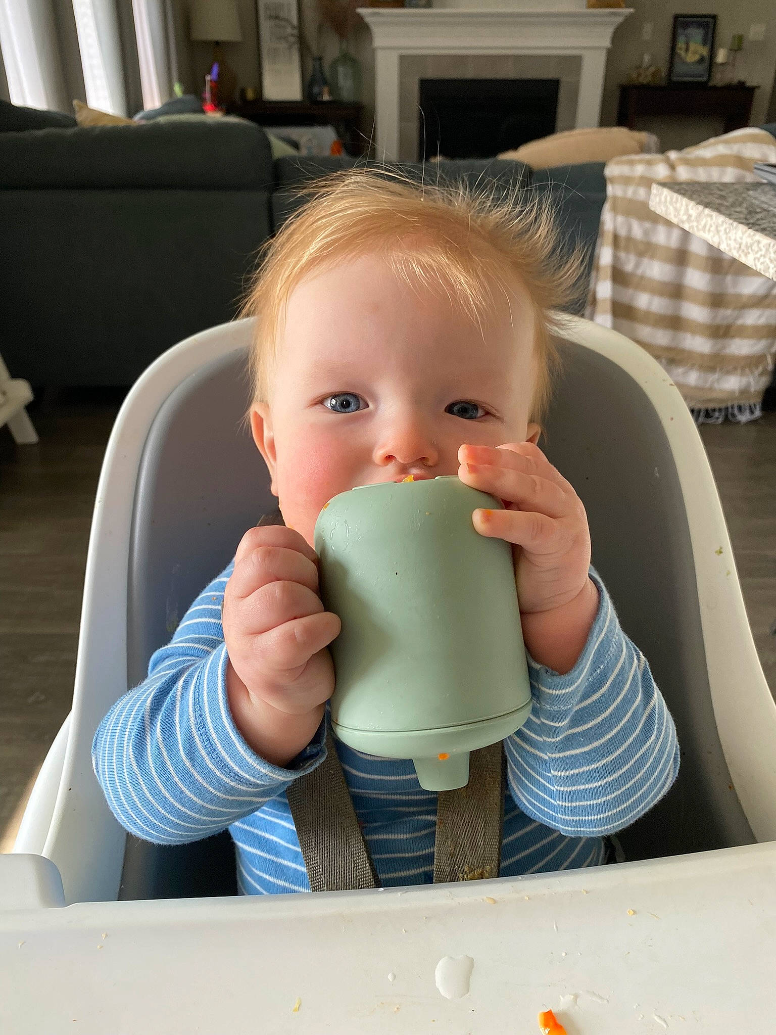 Hudson is registered to the contest to win money with this photo: baby, baby_toddler_clothing, bib, cheek, child, comfort, drinkware, eyebrow, eyelash, finger, fun, nail, nose, person, product, room, serveware, sitting, tableware, thumb