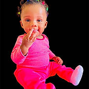 Blessing Athena is registered to the contest to win money with this photo: baby, child, infant, portrait, smiling, colorful_hair, striped_clothing, pink_pants, white_socks, sitting, curious_expression, cute, young_child, isolated_background, studio_style, small_ears, bright_colors, toddler, happy, indoor