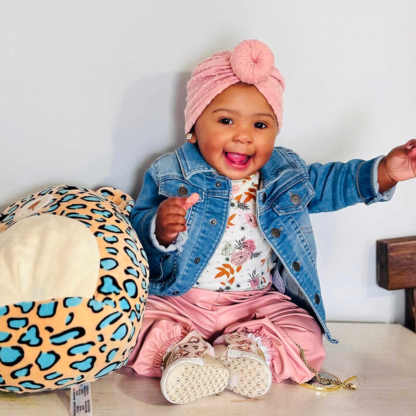 Neriah is registered to the contest to win money with this photo: baby, ball, cap, clothing, coat, face, football, happy, hat, head, jacket, jeans, pants, person, photography, portrait, sitting, soccer, soccerball, sport