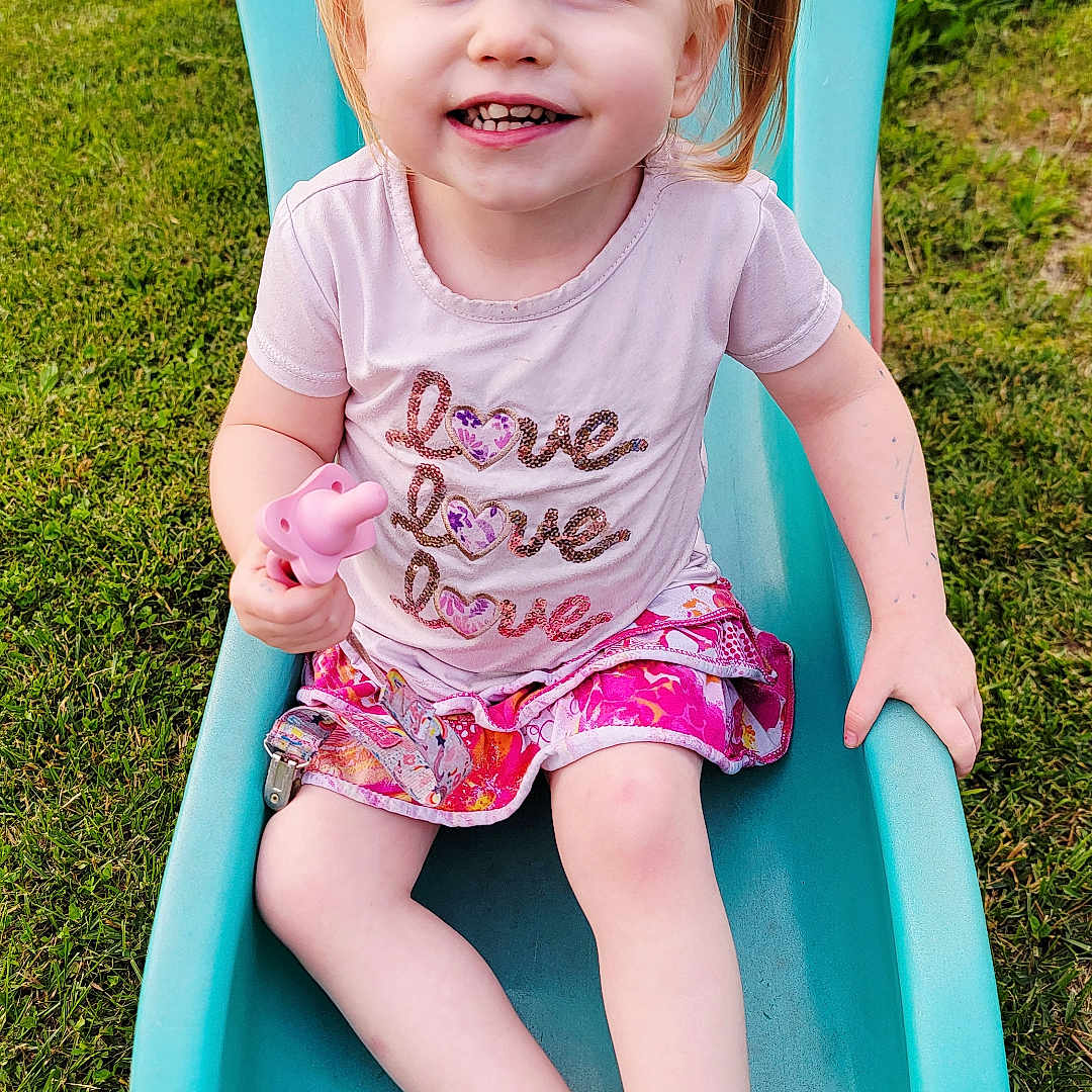 Willow joined the competition — help win amazing prizes! child, clothing, cute, feet, girl, grass, happy, nature, outdoor, person, pigtails, pink_shirt, playground, portrait, skirt, slide, smiling, summer, sunlight, toy