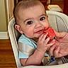 baby, infant, high_chair, watermelon, food, hand, smile, face, eyes, clothing, indoor, wooden_floor, door, home, cute, child, person, seatbelt, happy, eating