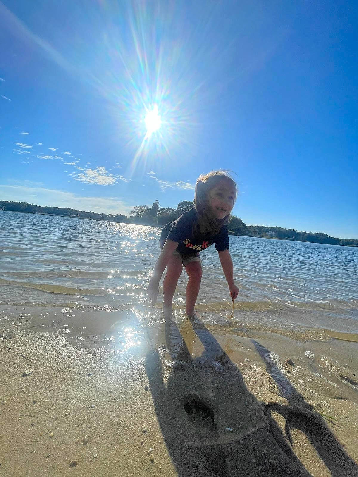 Shelby joined the competition — help win amazing prizes! beach, bermuda_shorts, body_of_water, cloud, fun, happy, horizon, joy, lake, landscape, leisure, ocean, people_in_nature, people_on_beach, person, sand, shorts, sky, sunlight, toddler