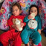 children, toddlers, siblings, babies, bottles, feeding, seated, chair, colorful, floral, princess, cartoon, clothing, red_outfit, blue_outfit, indoors, portrait, faces, family, cute