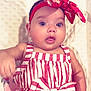 baby, infant, child, red_headband, striped_dress, bow, cute, portrait, closeup, soft_blanket, indoors, person, skin, face, expression, clothing, fashion, headwear, smile, young