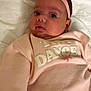 Leearnah is registered to the contest to win money with this photo: baby, infant, pink_headband, flower, sweater, tiny_dancer, towel, soft, chubby_cheeks, curious, lying_down, clothing, cute, portrait, closeup, child, headwear, indoors, person, adorable