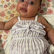 Leearnah is registered to the contest to win money with this photo: baby, infant, child, romper, purple, striped, bow, blanket, floral_pattern, cute, lying_down, skin, face, eyes, mouth, arm, hand, soft_fabric, indoor, portrait