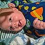 Buddy is registered to the contest to win money with this photo: baby, bedding, blanket, cheek, closeup, cozy, eye, face, fist, hand, happy, infant, newborn, onesie, pajamas, playful, shadow, smile, space_pattern, zipper