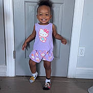 Rhayn joined the competition — help win amazing prizes! child, cute, door, floor, hair_up, happy, hello_kitty, home, indoor, mismatched_socks, person, playful, power_outlet, purple_clothing, shorts, sleeveless_shirt, smiling, standing, toddler, wall