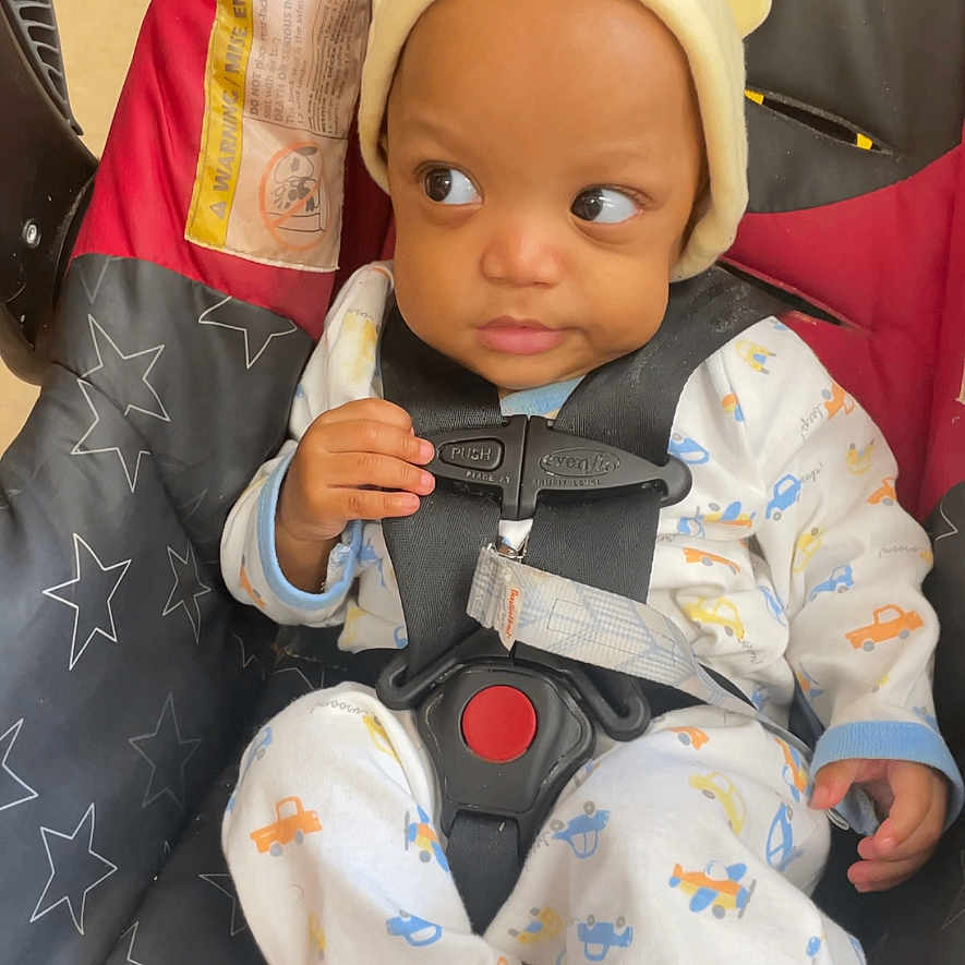 Dominick joined the competition — help win amazing prizes! baby, bodypart, bonnet, cap, clothing, coat, couch, doll, face, finger, furniture, hand, hat, head, hood, person, photography, portrait, sitting, toy