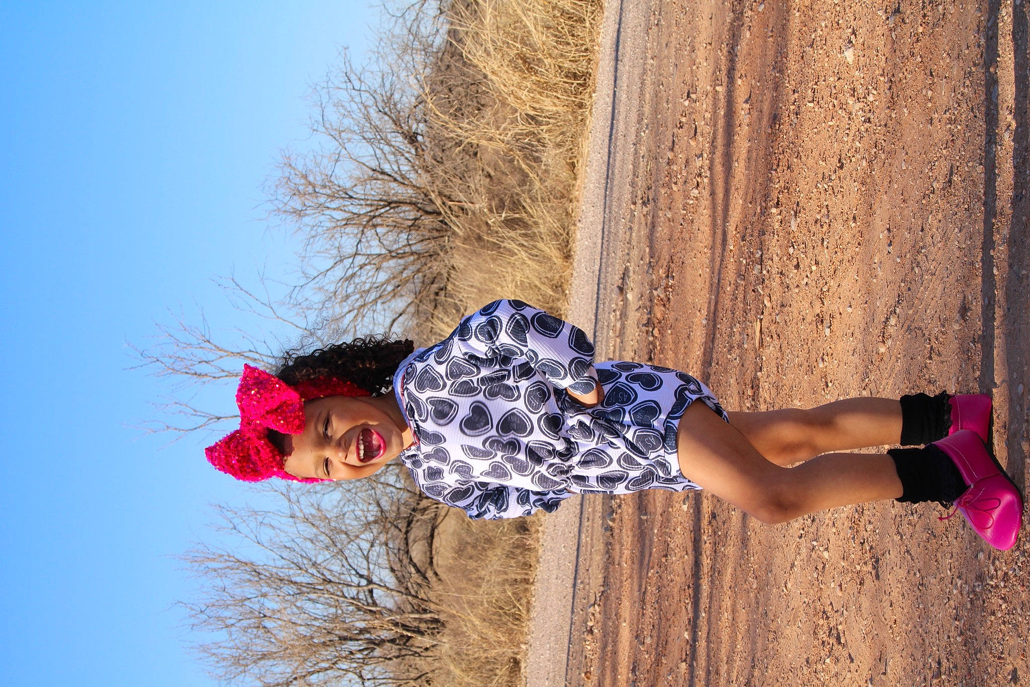 Isabel is registered to the contest to win money with this photo: arm, clothing, denim, dress, electric_blue, footwear, fun, happy, headwear, human_leg, jeans, landscape, leisure, people_in_nature, person, plant, sky, street_fashion, thigh, tree