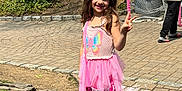 Lily Rose joined the competition — help win amazing prizes! cars, child, children, daylight, garden, girl, hockey_net, houses, outdoor, paved_driveway, peace_sign, pink_dress, playing, rocks, shoes, smiling, socks, straw_hat, sunny, trees