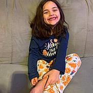 Lily Rose is registered to the contest to win money with this photo: casual_clothing, child, comfortable, couch, cozy, cute, foot, girl, happy, home, indoor, leisure, long_hair, pajamas, person, portrait, relaxed, sitting, smiling, youth