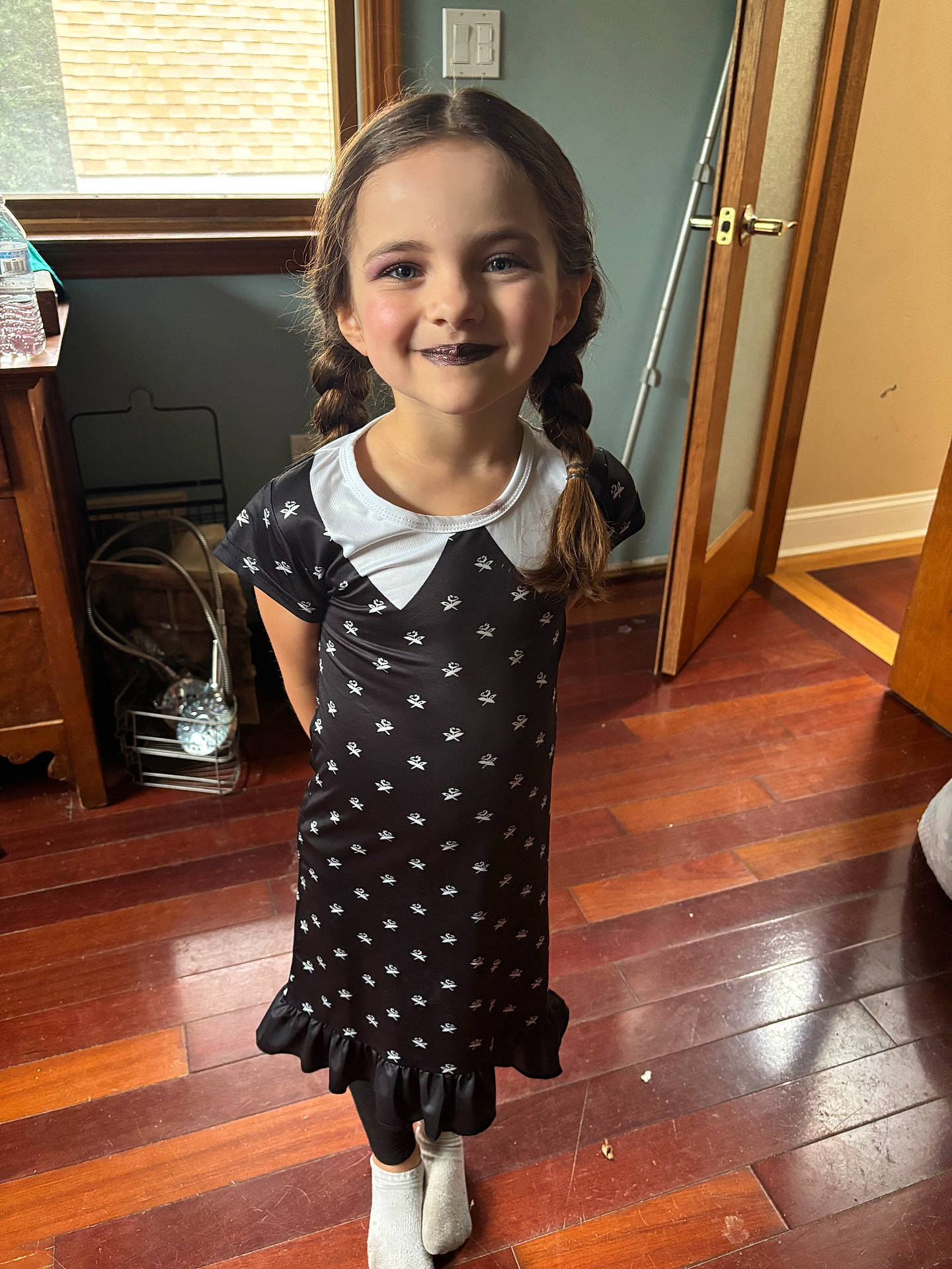 Lily Rose joined the competition — help win amazing prizes! black_dress, braids, child, door, dress, face, furniture, girl, happy, indoors, legs, natural_light, portrait, smile, socks, standing, water_bottle, white_patterns, window, wooden_floor