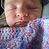 Aria is registered to the contest to win money with this photo: newborn, baby, infant, sleeping, face, portrait, blanket, swaddled, pastel, pink, blue, purple, cozy, peaceful, indoors, close_up, head, eyes_closed, soft_texture, photography