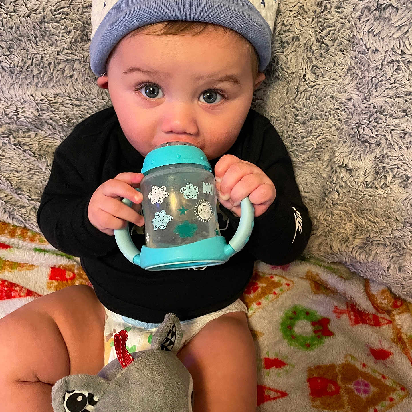 Sa Quoreii is registered to the contest to win money with this photo: baby, beanie, beverage, bodypart, cap, clothing, coffee, coffeecup, couch, cup, face, finger, furniture, glove, hand, hat, head, person, photography, portrait