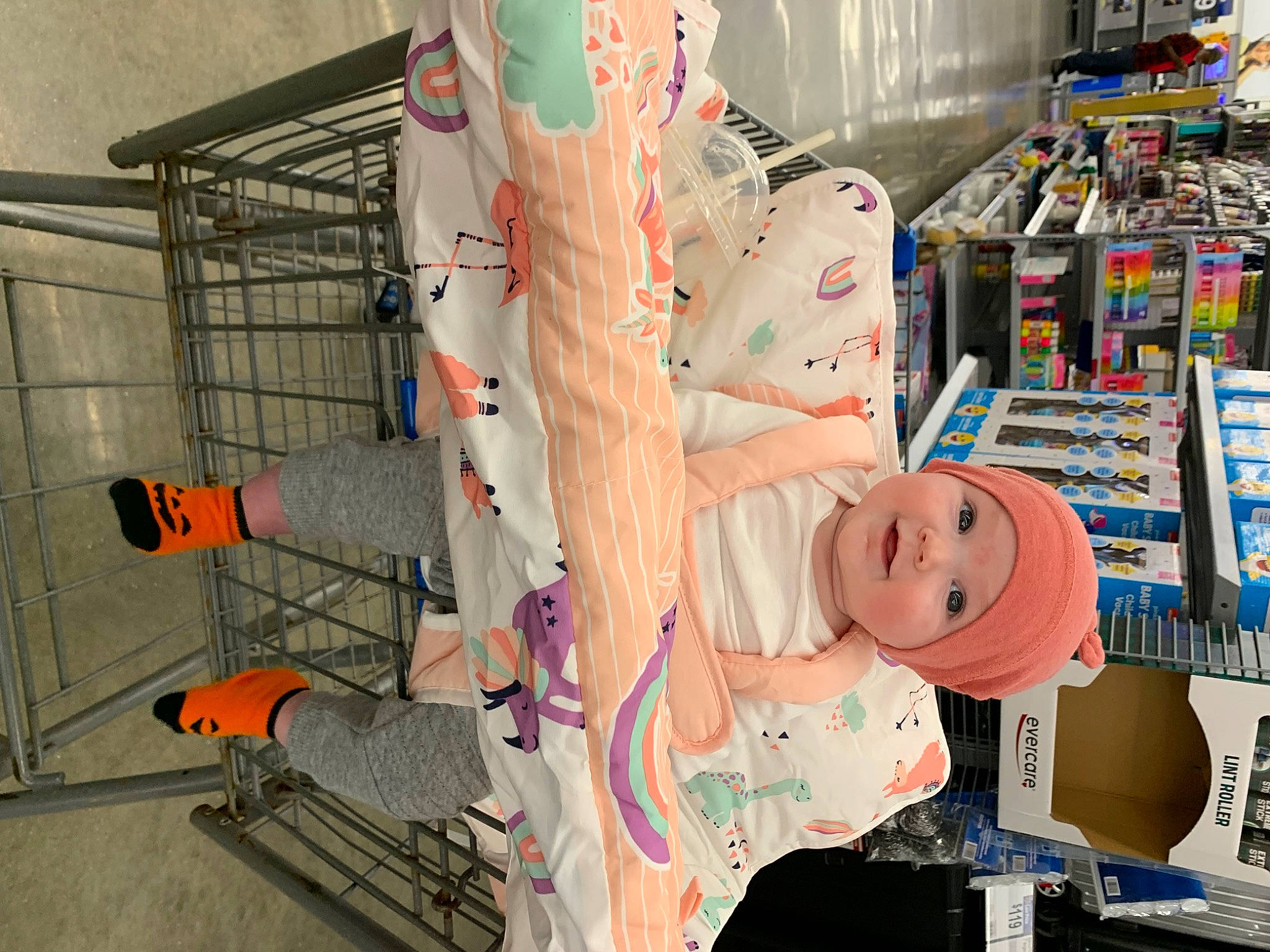 Macy is registered to the contest to win money with this photo: building, carmine, child, convenience_store, flooring, fun, headwear, machine, person, plastic, retail, room, service, shelf, shelving, stuffed_toy, toy, visual_arts
