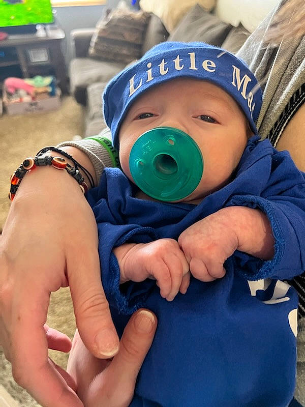 Elijah is registered to the contest to win money with this photo: baby, baby_toddler_clothing, cap, child, electric_blue, eye, finger, gesture, goggles, green, hand, happy, hat, headwear, jacket, person, personal_protective_equipment, recreation, skin, sun_hat