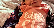 Amirah joined the competition — help win amazing prizes! baby, smiling, sleeping, headband, bow, blanket, clothing, infant, cute, indoors, portrait, child, cozy, pink, floral, soft, happiness, peaceful, newborn, resting