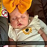 Amirah is registered to the contest to win money with this photo: baby, sleeping, bow, orange_bow, car_seat, infant, child, sunflower, white_clothing, peaceful, portrait, cute, indoors, screenshot, social_media, emoji_overlay, face, head, young_child, resting