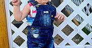 Amirah joined the competition — help win amazing prizes! toddler, child, denim_overalls, blue_bow, headband, barefoot, blanket, outdoor, fence, lattice, curious, standing, grass, patriotic_colors, red, white, blue, person, summer, cute