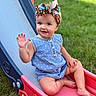 toddler, child, outdoor, slide, playground, grass, smiling, waving, headband, romper, blue_clothing, barefoot, summer, happy, cute, fun, play, park, daylight, portrait