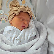 Lottie-May is registered to the contest to win money with this photo: newborn, baby, sleeping, blanket, headband, bow, bed, bedding, pattern, rainbow, soft, cute, infant, wrapped, clothing, peaceful, rest, child, indoors, closeup