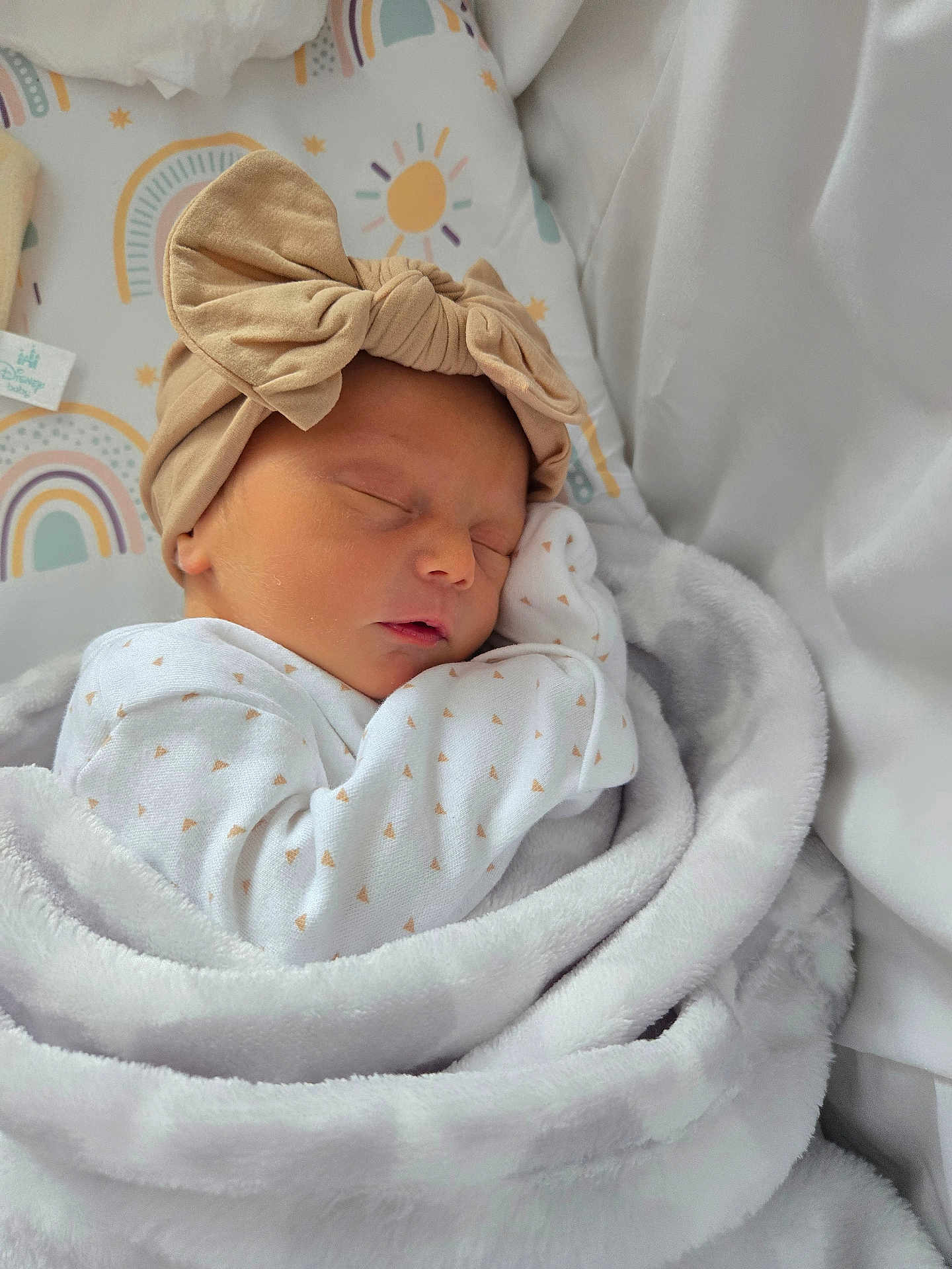 Lottie-May is registered to the contest to win money with this photo: newborn, baby, sleeping, blanket, headband, bow, bed, bedding, pattern, rainbow, soft, cute, infant, wrapped, clothing, peaceful, rest, child, indoors, closeup