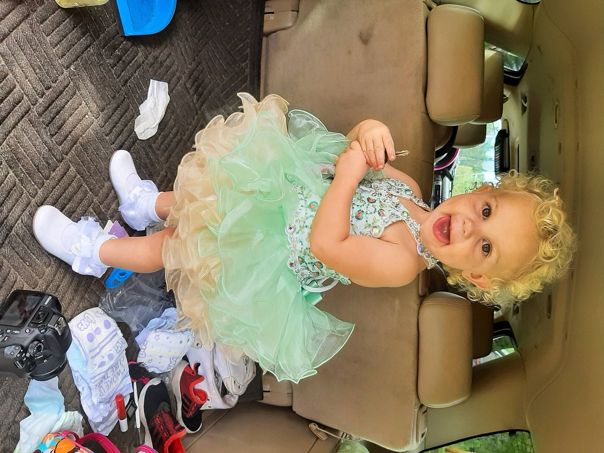 Jessie is registered to the contest to win money with this photo: abdomen, baby, baby_products, baby_toddler_clothing, blue, child, costume, event, fun, happy, headpiece, human_body, human_leg, jewellery, person, pink, sitting, skin, smile, thigh