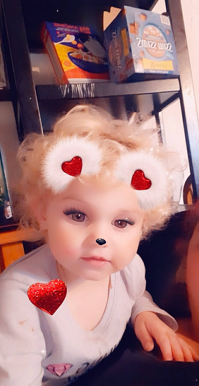 Jessie is registered to the contest to win money with this photo: baby_products, baby_toddler_clothing, cap, costume_hat, dress, eyelash, fictional_character, hair_accessory, hat, headband, headpiece, helmet, lip, nose, party_supply, person, pink, skin, sunglasses, toddler